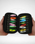 Set of colorful fishing lures in a black case held by hands on a white background